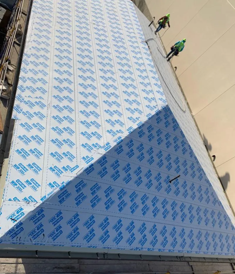 Professional roofers installing underlayment on a metal roof in Lebanon